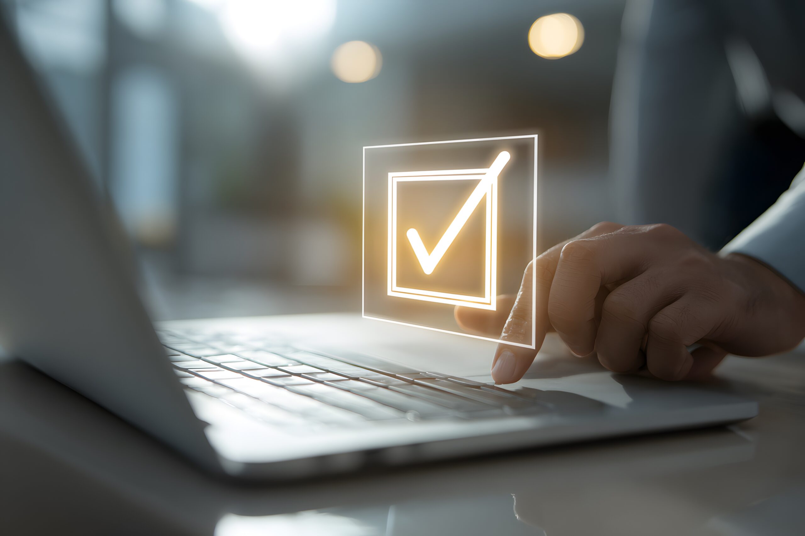 Person using laptop with digital check mark hovering above the keyboard with finger pressing key